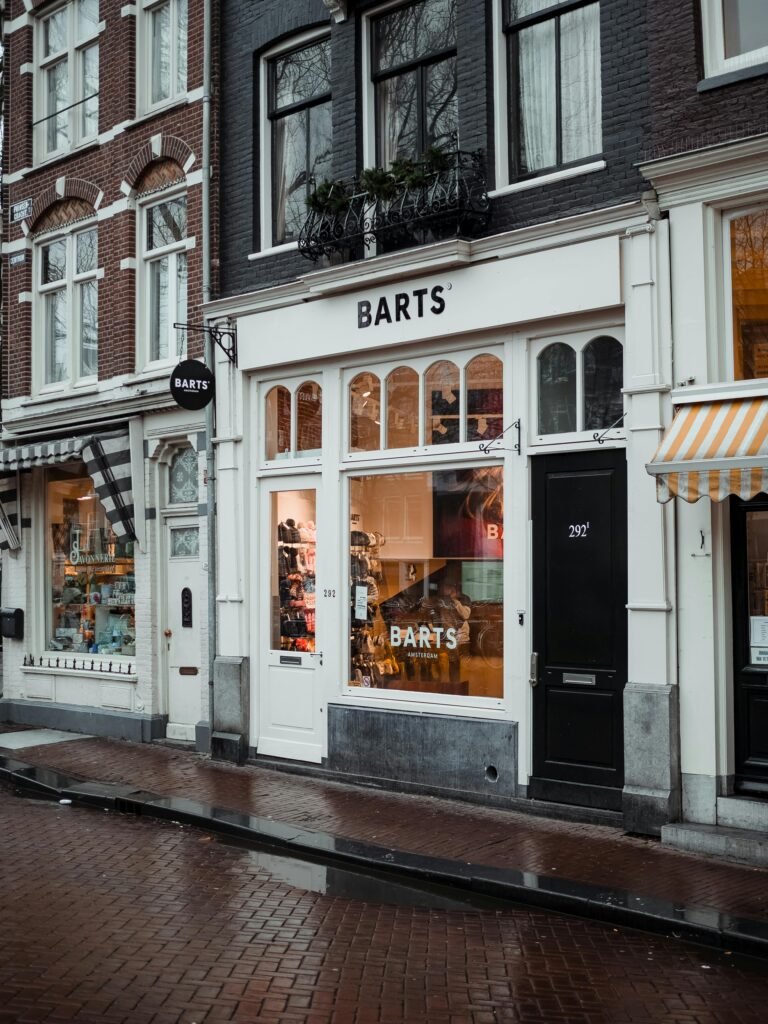 A cozy urban storefront with unique architecture and welcoming signage captured on a rainy day.