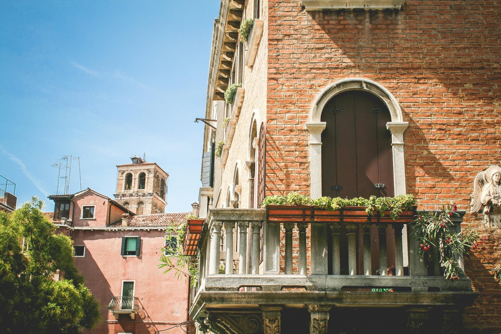 A stunning brick facade with a decorative balcony, capturing the essence of Italian architecture.