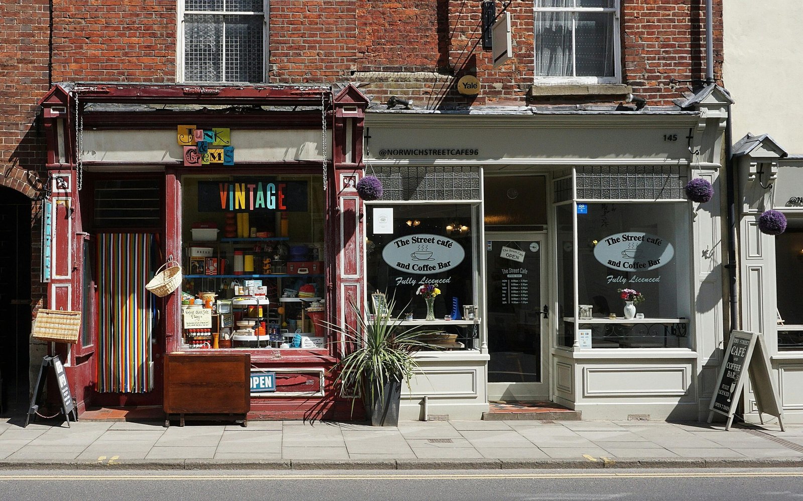 Vintage shop and cafe in Norwich showcasing eclectic storefronts and vibrant signage.