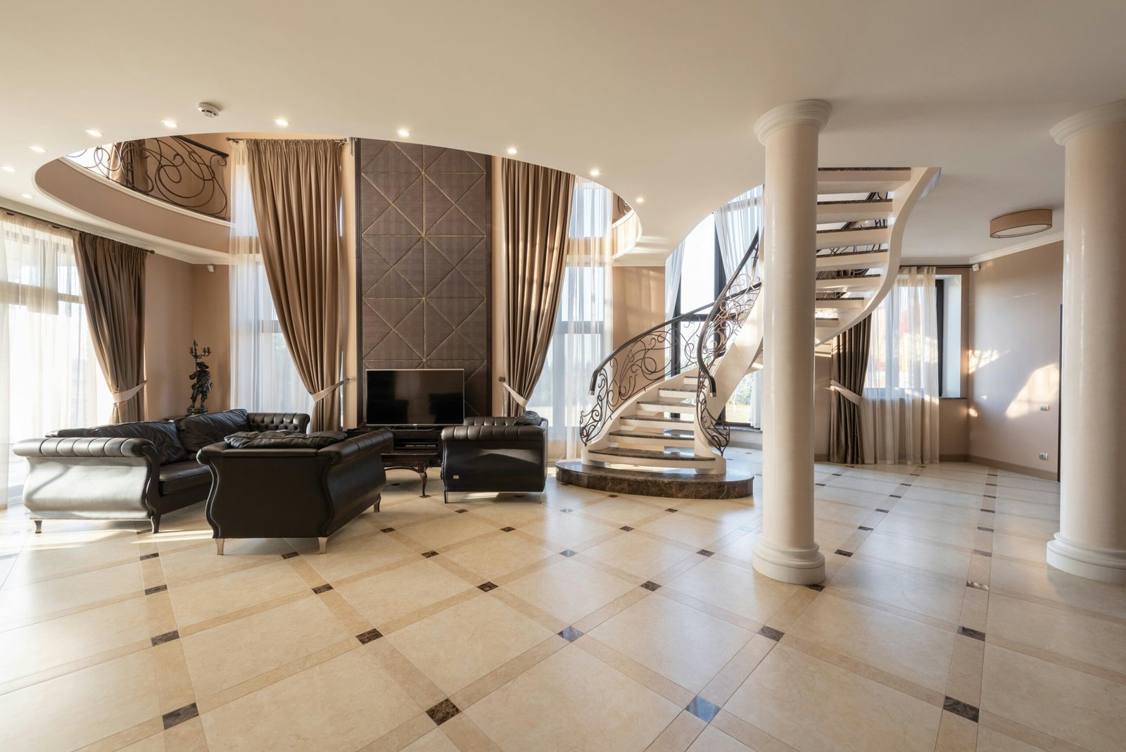 Elegant living room featuring a spiral staircase and classic furniture in a spacious modern home.